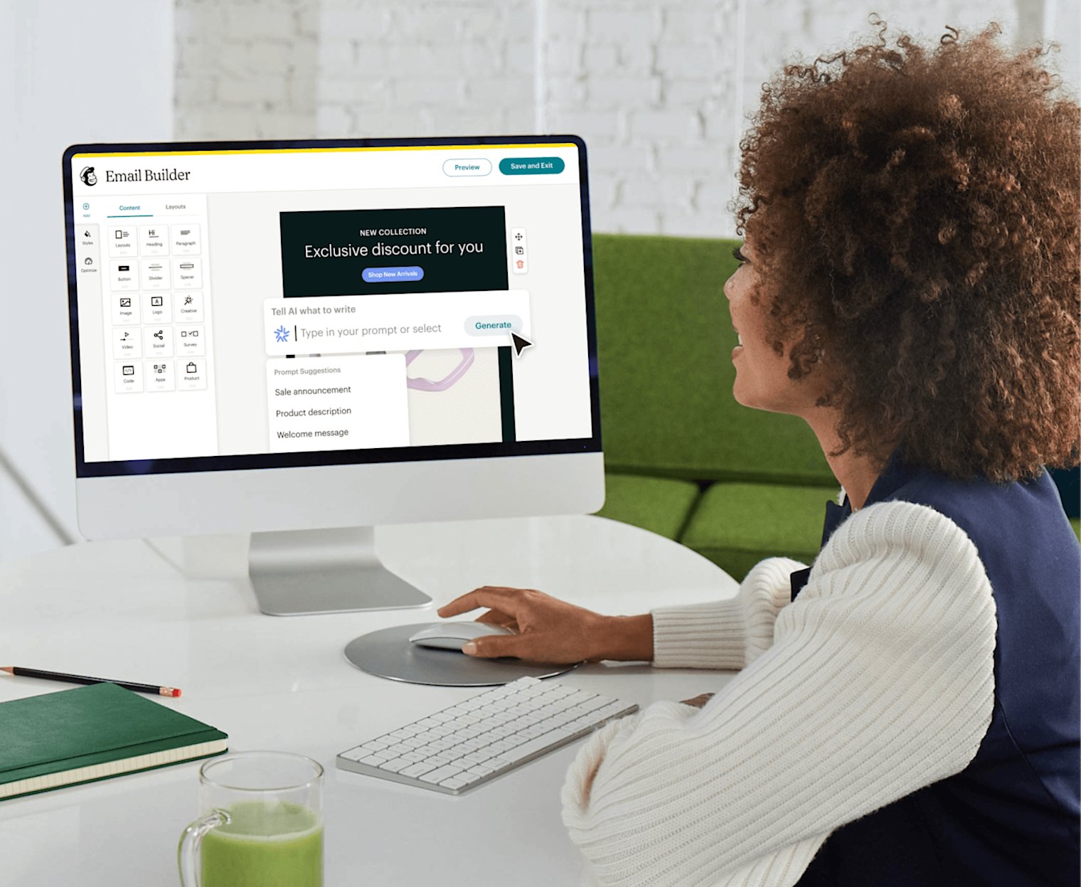 Image of person in sitting at desk looking at their computer monitor where they are using Mailchimp’s power and intuitive Email Builder feature to create personalized email campaigns to marketing their business to their customers.